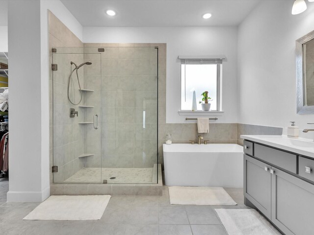 1708 Jamestown Dr, Forney, TX 75126 - full bathroom featuring a shower stall, tile patterned floors, vanity, a soaking tub, and a spacious closet