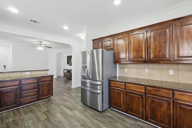 544 Baverton Ln, Fort Worth, TX 76052 - kitchen with stainless steel refrigerator with ice dispenser, arched walkways, ceiling fan, tasteful backsplash, and dark wood finished floors