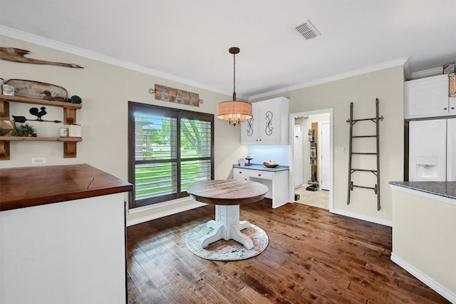 218 Cayuga Trl, Lake Kiowa, TX 76240 - dining space with dark wood-style flooring, ornamental molding, baseboards, and a chandelier