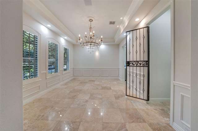 5622 Braemar Dr, Frisco, TX 75034 - hall with a chandelier, a decorative wall, a raised ceiling, recessed lighting, and ornamental molding