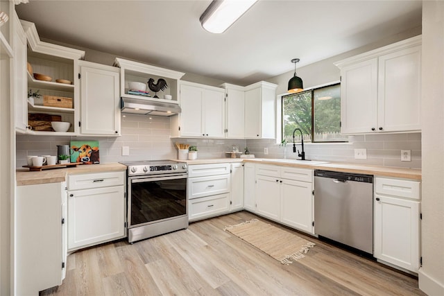 4702 Pamela Dr, Abilene, TX 79606 - kitchen with open shelves, appliances with stainless steel finishes, a sink, tasteful backsplash, and light wood-style flooring
