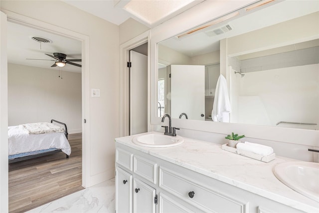 4702 Pamela Dr, Abilene, TX 79606 - ensuite bathroom with a ceiling fan, double vanity, marble finish floors, and baseboards