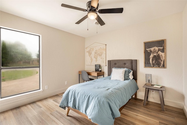 4702 Pamela Dr, Abilene, TX 79606 - bedroom with wood finished floors, baseboards, and a ceiling fan