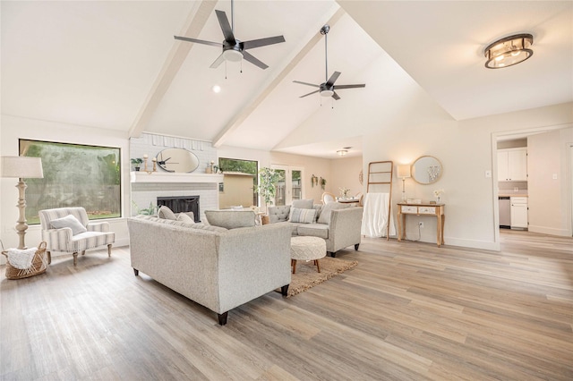 4702 Pamela Dr, Abilene, TX 79606 - living area featuring light wood-style flooring, a ceiling fan, high vaulted ceiling, beamed ceiling, and a fireplace