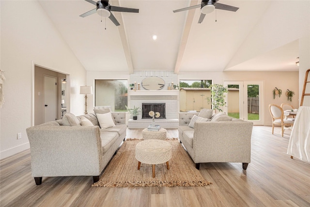 4702 Pamela Dr, Abilene, TX 79606 - living room with a ceiling fan, wood finished floors, high vaulted ceiling, a brick fireplace, and baseboards