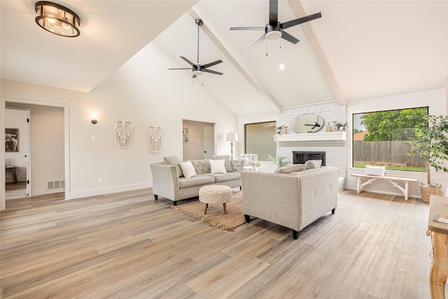 4702 Pamela Dr, Abilene, TX 79606 - living room featuring ceiling fan, high vaulted ceiling, a brick fireplace, light wood-style floors, and beam ceiling