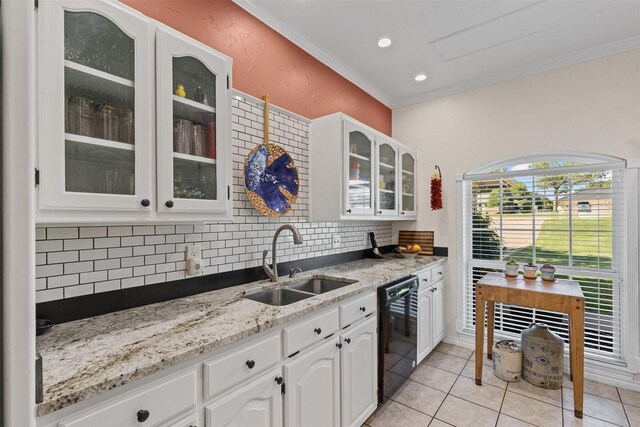 711 Aqua Vista Dr, Granbury, TX 76049 - kitchen featuring a sink, dishwasher, decorative backsplash, crown molding, and glass insert cabinets