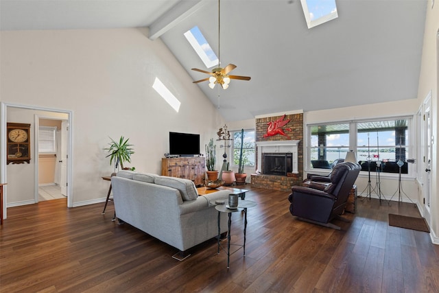 711 Aqua Vista Dr, Granbury, TX 76049 - living room featuring a skylight, high vaulted ceiling, a brick fireplace, ceiling fan, and dark wood finished floors