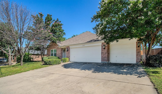 3809 San Lorenzo Dr, Denton, TX 76210 - view of property hidden behind natural elements with brick siding, an attached garage, driveway, and a shingled roof