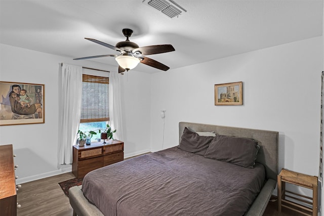 11202 Myrtice Dr, Dallas, TX 75228 - bedroom with wood finished floors, baseboards, and a ceiling fan