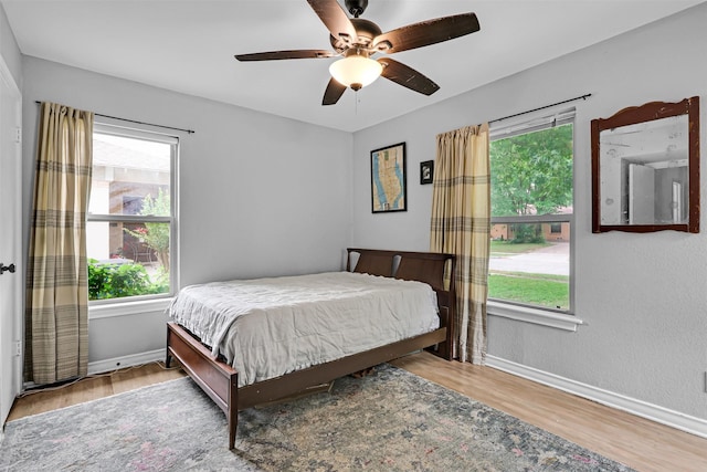 11202 Myrtice Dr, Dallas, TX 75228 - bedroom featuring multiple windows, wood finished floors, baseboards, and ceiling fan