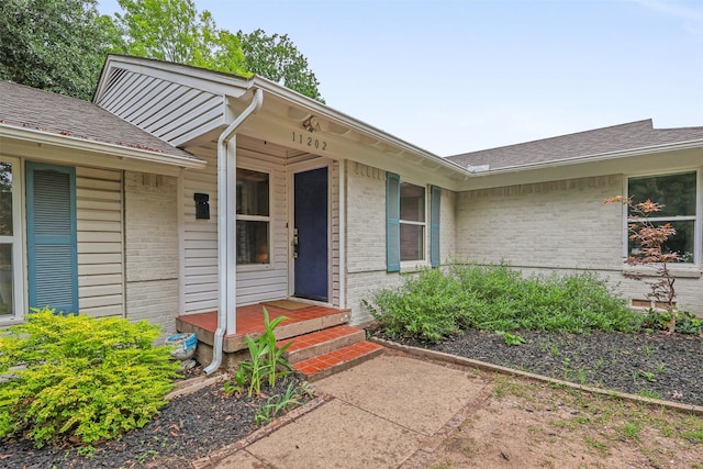 11202 Myrtice Dr, Dallas, TX 75228 - view of exterior entry featuring brick siding and a shingled roof