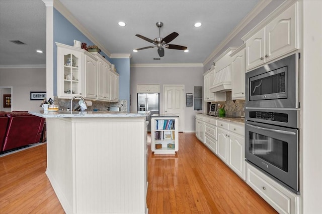 809 Remington Park, Robinson, TX 76706 - kitchen with stainless steel appliances, a peninsula, glass insert cabinets, decorative backsplash, and recessed lighting