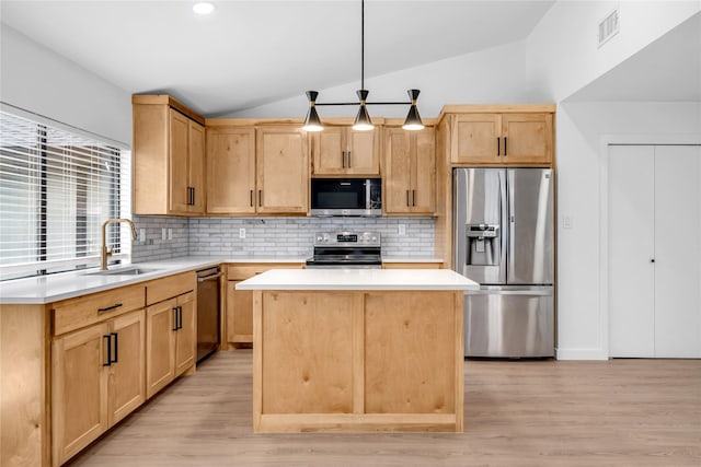 808 Warwick Dr, Plano, TX 75023 - kitchen featuring appliances with stainless steel finishes, light brown cabinets, a sink, vaulted ceiling, and backsplash