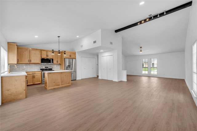 808 Warwick Dr, Plano, TX 75023 - kitchen featuring lofted ceiling, appliances with stainless steel finishes, open floor plan, light countertops, and ceiling fan
