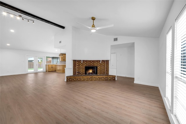808 Warwick Dr, Plano, TX 75023 - unfurnished living room featuring a ceiling fan, wood finished floors, a brick fireplace, and baseboards