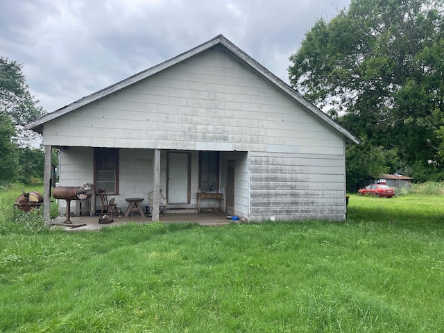 210 E Colorado, Groesbeck, TX 76642 - rear view of property featuring a lawn and a porch