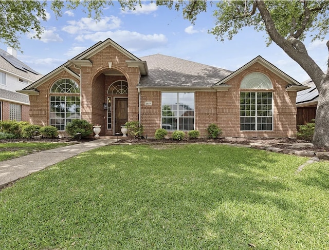 3927 Walden Way, Dallas, TX 75287 - view of front of house with brick siding, a front lawn, and roof with shingles