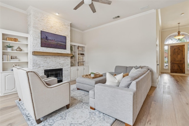 3927 Walden Way, Dallas, TX 75287 - living area featuring light wood finished floors, a fireplace, ceiling fan, and ornamental molding