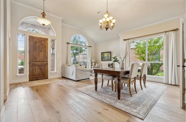 3927 Walden Way, Dallas, TX 75287 - foyer entrance featuring a chandelier, light wood-style floors, lofted ceiling, crown molding, and baseboards
