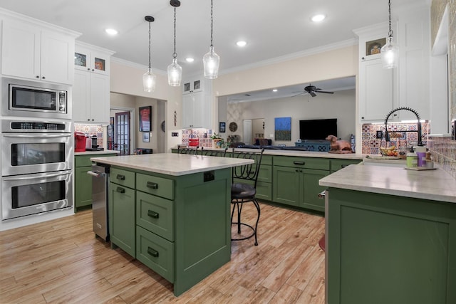 18551 Lazy Ln, Flint, TX 75762 - kitchen featuring green cabinetry, stainless steel appliances, white cabinets, backsplash, and ornamental molding