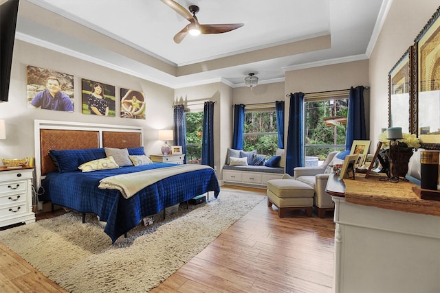 18551 Lazy Ln, Flint, TX 75762 - bedroom featuring a raised ceiling, hardwood / wood-style floors, a ceiling fan, and crown molding