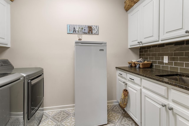 18551 Lazy Ln, Flint, TX 75762 - washroom with washer and dryer, cabinet space, and baseboards