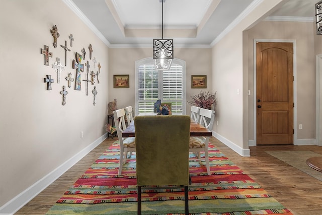 18551 Lazy Ln, Flint, TX 75762 - dining room with a tray ceiling, wood finished floors, ornamental molding, and baseboards