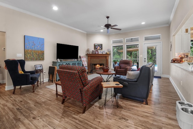 18551 Lazy Ln, Flint, TX 75762 - living area featuring ceiling fan, wood finished floors, a warm lit fireplace, recessed lighting, and crown molding