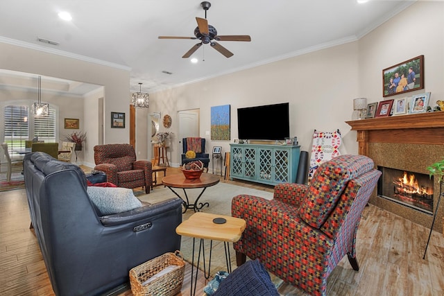 18551 Lazy Ln, Flint, TX 75762 - living area featuring wood finished floors, ceiling fan, a tile fireplace, recessed lighting, and crown molding