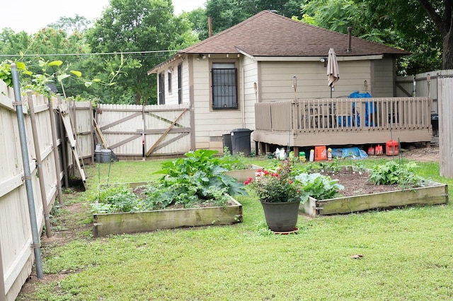 1611 Ave B, Dallas, TX 75203 - back of house featuring a garden, a wooden deck, roof with shingles, and a gate