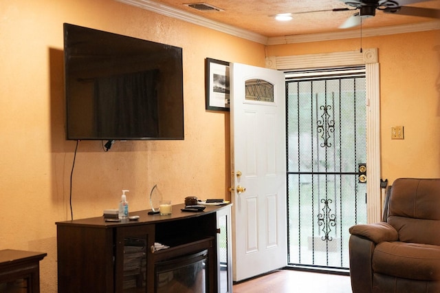 1611 Ave B, Dallas, TX 75203 - foyer with crown molding, a ceiling fan, and a textured wall