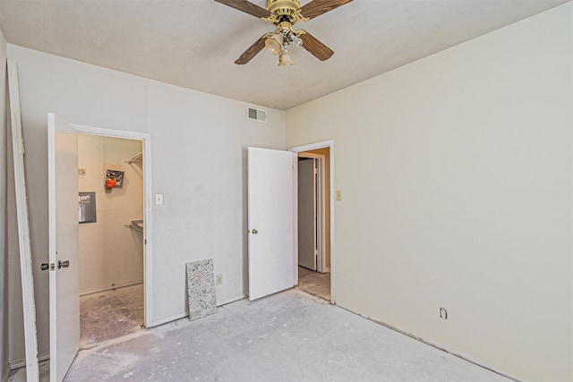 4430 Point Blvd Unit 204, Garland, TX 75043 - unfurnished bedroom featuring a walk in closet, concrete floors, and a ceiling fan