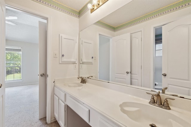 2822 Roundrock, Mckinney, TX 75072 - bathroom featuring a textured ceiling, double vanity, and baseboards