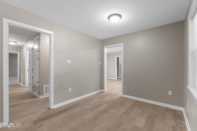 9312 Pine Grove St, Shreveport, LA 71118 - unfurnished room with attic access, light wood-style floors, and baseboards