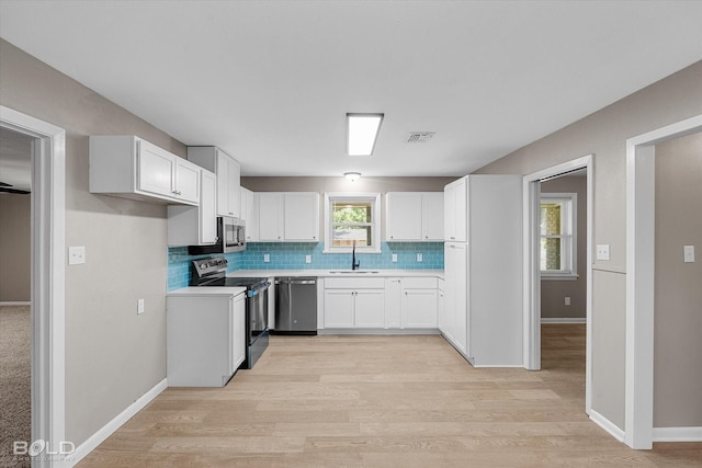 9312 Pine Grove St, Shreveport, LA 71118 - kitchen with appliances with stainless steel finishes, backsplash, a sink, and light wood finished floors