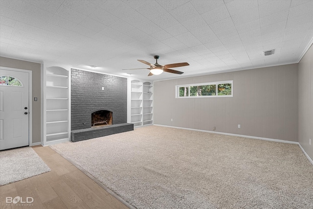 9312 Pine Grove St, Shreveport, LA 71118 - unfurnished living room featuring built in features, ceiling fan, a large fireplace, and baseboards