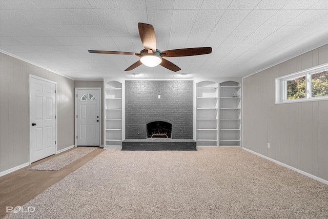 9312 Pine Grove St, Shreveport, LA 71118 - unfurnished living room featuring ceiling fan, built in features, a fireplace, baseboards, and crown molding