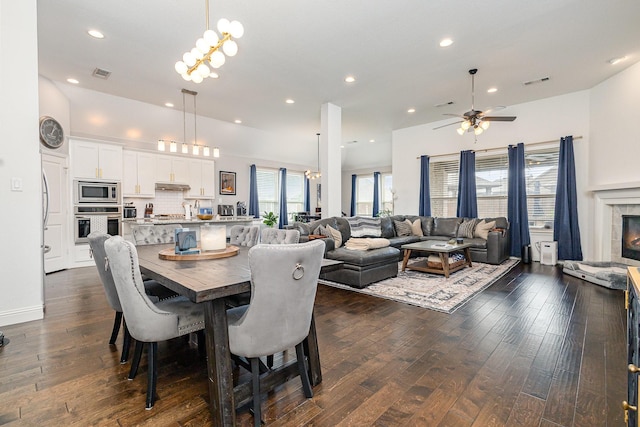 1502 Barley Ct, Forney, TX 75126 - dining space featuring a ceiling fan, dark wood-style flooring, recessed lighting, and a fireplace