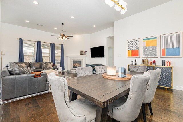 1502 Barley Ct, Forney, TX 75126 - dining area featuring dark wood-type flooring, recessed lighting, ceiling fan, a glass covered fireplace, and a chandelier