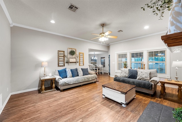 112 Topaz Cir, Hewitt, TX 76643 - living area with ceiling fan, wood finished floors, baseboards, ornamental molding, and a textured ceiling