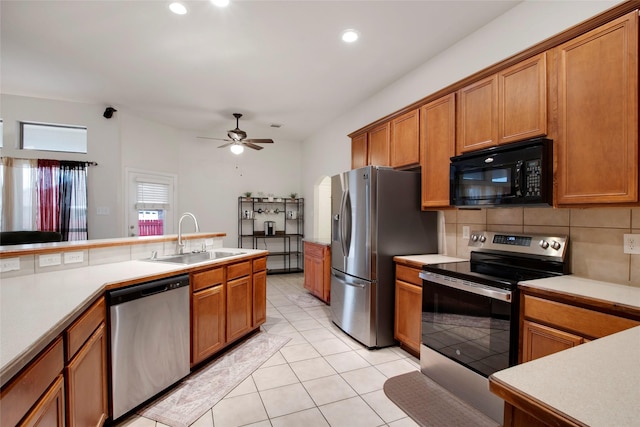1212 Live Oak St, Royse City, TX 75189 - kitchen featuring stainless steel appliances, a sink, brown cabinets, light countertops, and ceiling fan