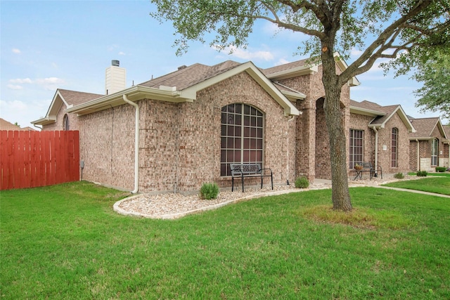 1212 Live Oak St, Royse City, TX 75189 - view of property exterior featuring a chimney, brick siding, and roof with shingles