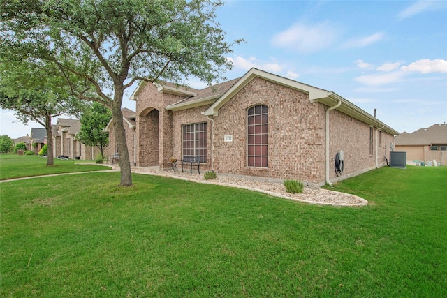 1212 Live Oak St, Royse City, TX 75189 - view of front of house featuring a front lawn, cooling unit, and brick siding