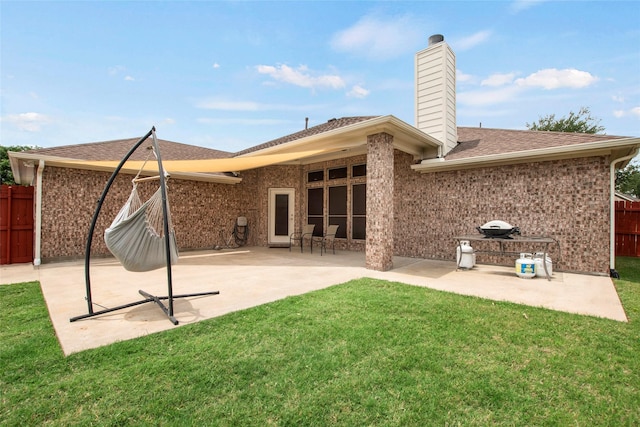1212 Live Oak St, Royse City, TX 75189 - back of house featuring a patio, a chimney, brick siding, and a shingled roof