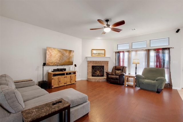 1212 Live Oak St, Royse City, TX 75189 - living room with ceiling fan, wood finished floors, a brick fireplace, and baseboards