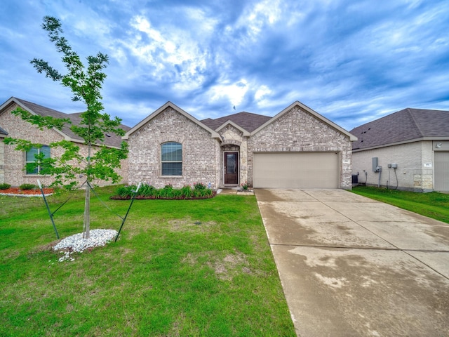 316 Crossvine Way, Princeton, TX 75407 - french country home featuring an attached garage, brick siding, concrete driveway, and a front yard