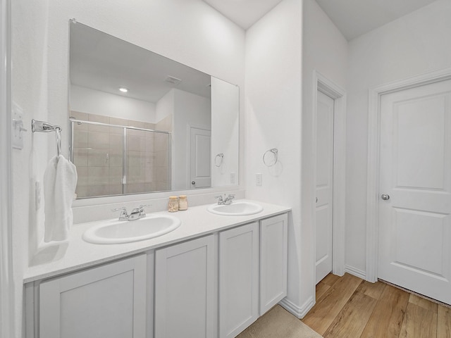 316 Crossvine Way, Princeton, TX 75407 - full bathroom with a stall shower, wood finished floors, and double vanity