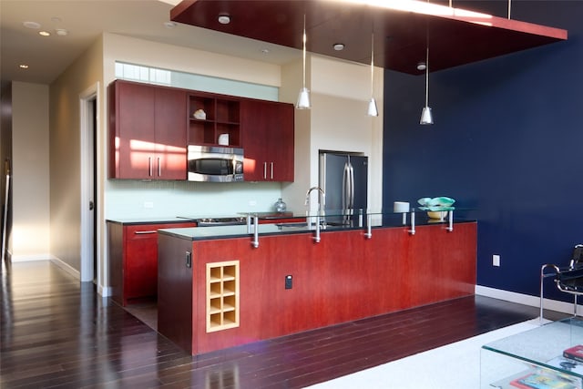 2600 W 7th St Unit 1713, Fort Worth, TX 76107 - kitchen featuring appliances with stainless steel finishes, dark wood-type flooring, reddish brown cabinets, baseboards, and recessed lighting