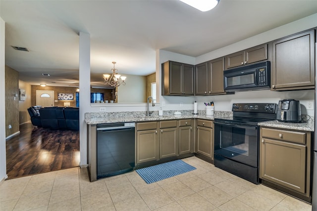1224 Evergreen St, Royse City, TX 75189 - kitchen featuring black appliances, a sink, a chandelier, light stone counters, and light tile patterned floors